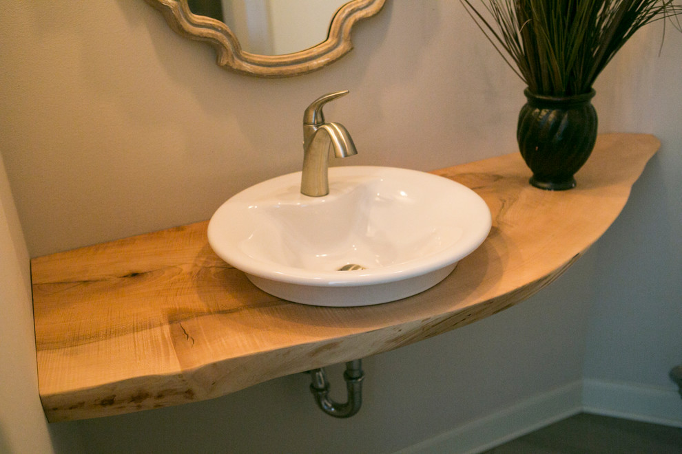Example of a mountain style bathroom design with a vessel sink, wood countertops and beige countertops