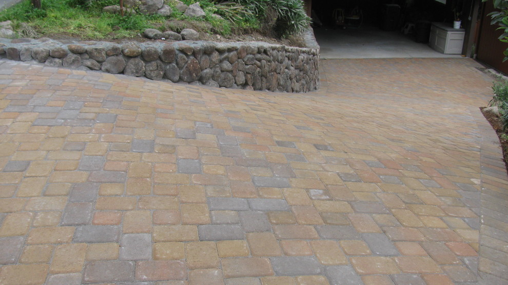This is an example of a mid-sized contemporary front yard partial sun driveway in San Francisco with concrete pavers.