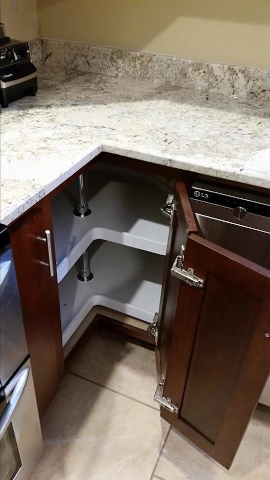 This is an example of a traditional kitchen in Other with raised-panel cabinets, dark wood cabinets, granite benchtops, stainless steel appliances and ceramic floors.