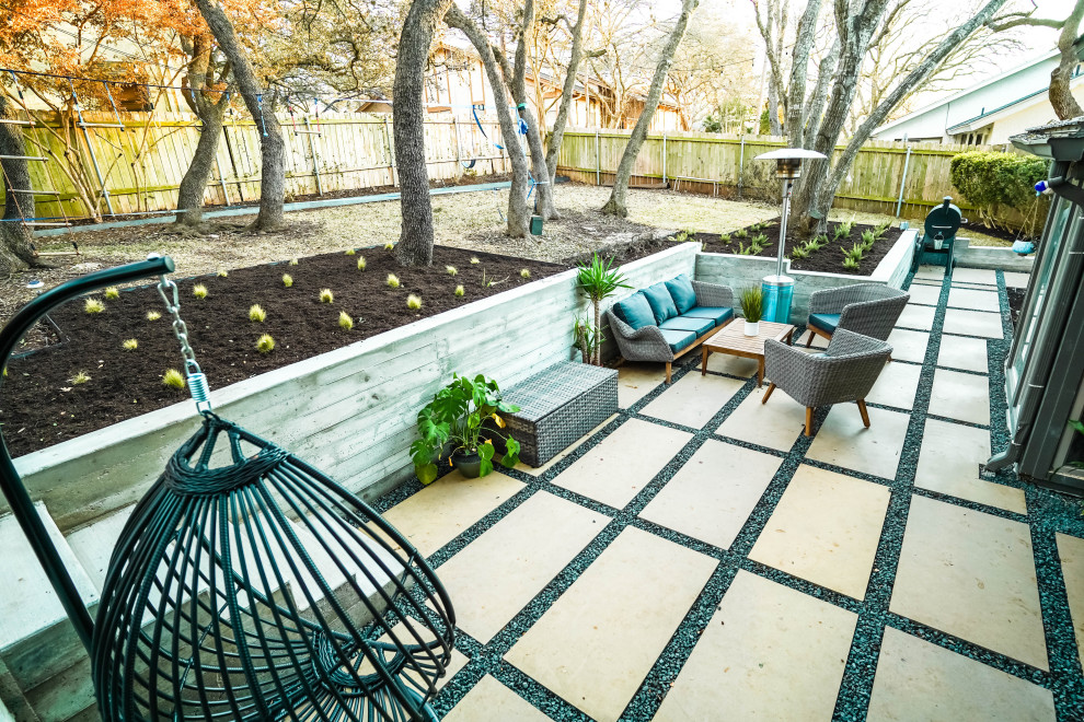 Inspiration for a mid-sized contemporary backyard patio in Austin with natural stone pavers.