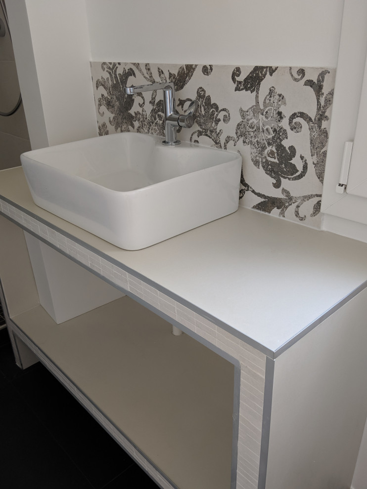 Design ideas for a small transitional 3/4 bathroom in Paris with open cabinets, beige cabinets, an alcove shower, black and white tile, ceramic tile, white walls, ceramic floors, a drop-in sink, tile benchtops, black floor, a sliding shower screen, beige benchtops and a single vanity.