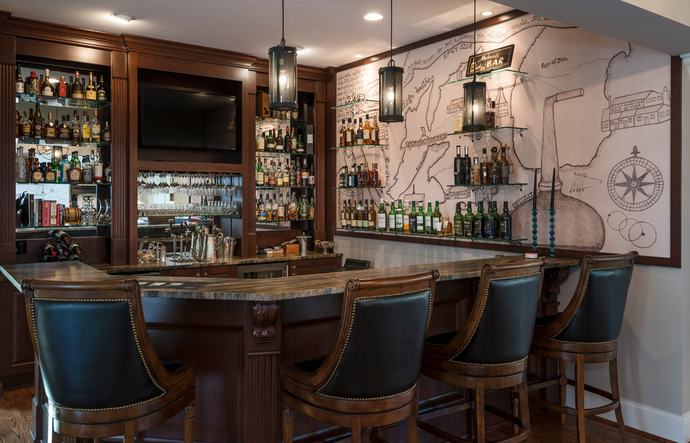 Large contemporary u-shaped seated home bar in Cincinnati with an undermount sink, raised-panel cabinets, dark wood cabinets, mirror splashback, dark hardwood floors and brown floor.