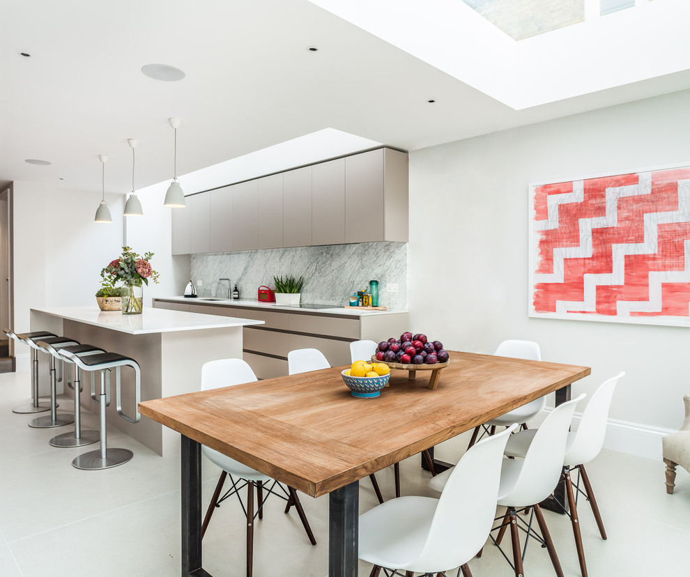 Photo of a contemporary kitchen/dining combo in London with ceramic floors, white walls and no fireplace.