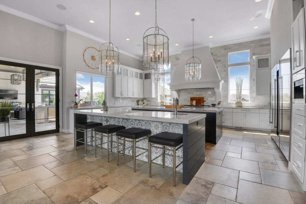 Design ideas for a transitional u-shaped kitchen in Kansas City with an undermount sink, shaker cabinets, white cabinets, grey splashback, stainless steel appliances, multiple islands, multi-coloured floor and grey benchtop.