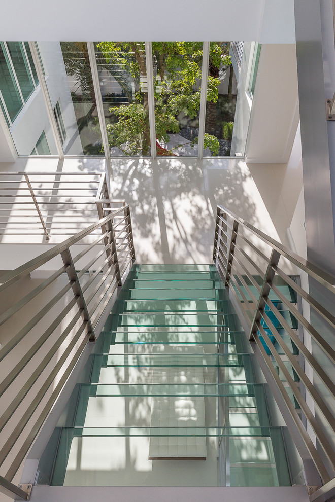 This is an example of a large modern glass u-shaped staircase in Miami.