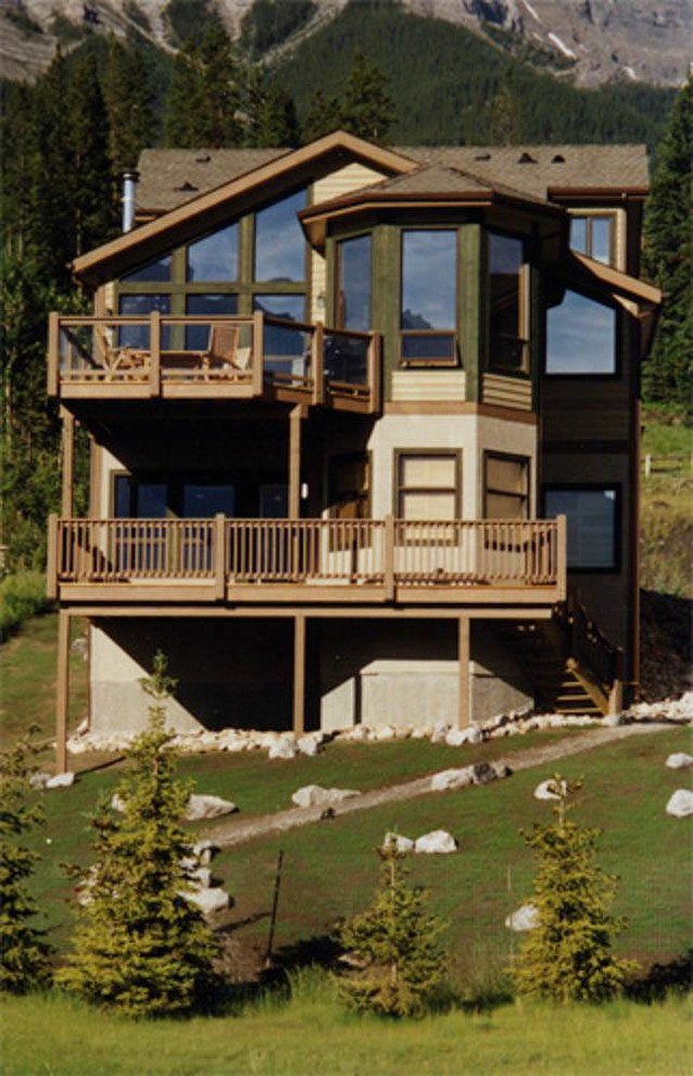 Inspiration for a huge rustic backyard deck remodel in Calgary