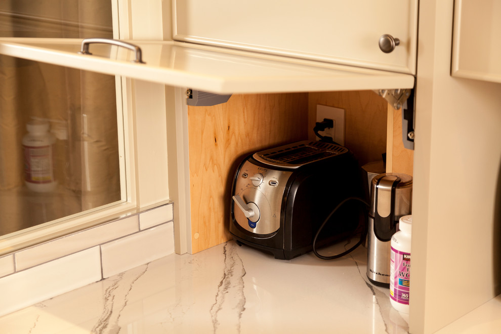 Inspiration for a small transitional l-shaped kitchen remodel in Toronto with an undermount sink, beaded inset cabinets, beige cabinets, quartzite countertops, stainless steel appliances and an island