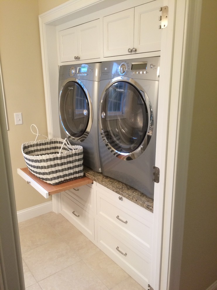 This is an example of a contemporary laundry room in Boston with white cabinets, granite benchtops, a side-by-side washer and dryer and recessed-panel cabinets.