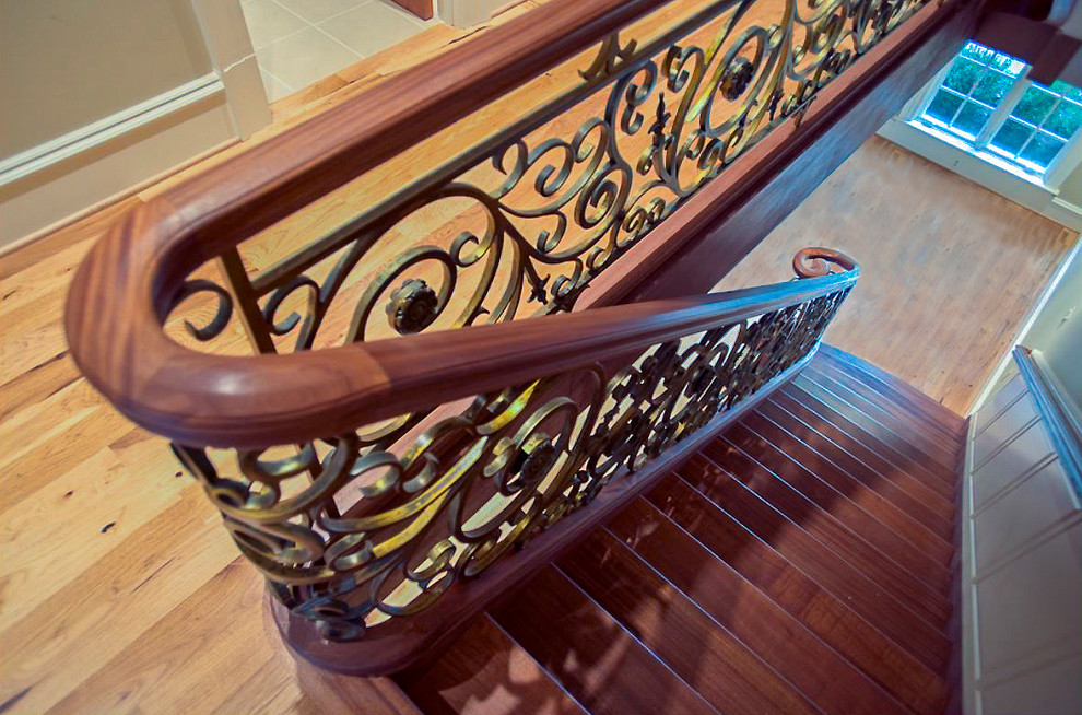 Photo of an expansive mediterranean wood floating staircase in DC Metro with wood risers and mixed railing.