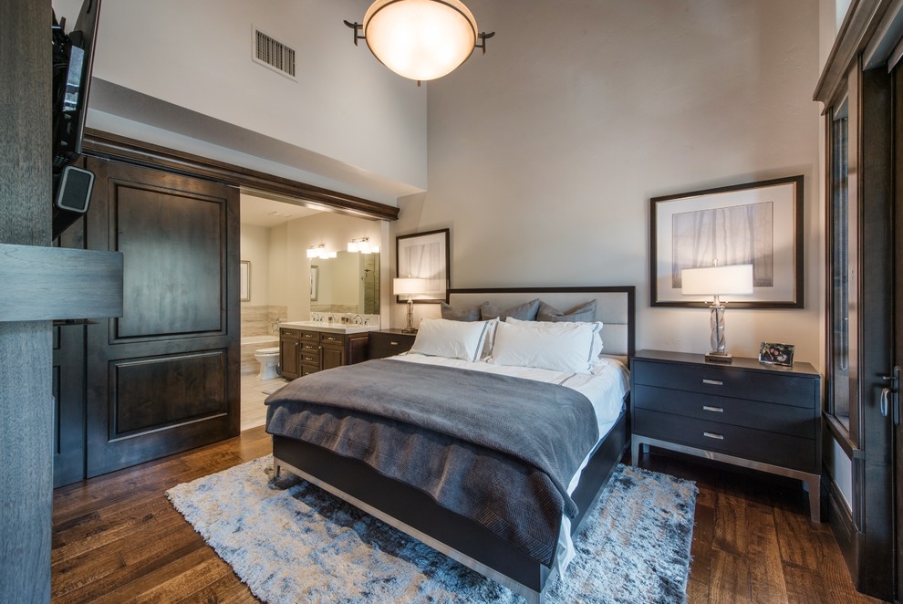 Design ideas for a small transitional master bedroom in Salt Lake City with grey walls, dark hardwood floors, a standard fireplace, a wood fireplace surround and brown floor.