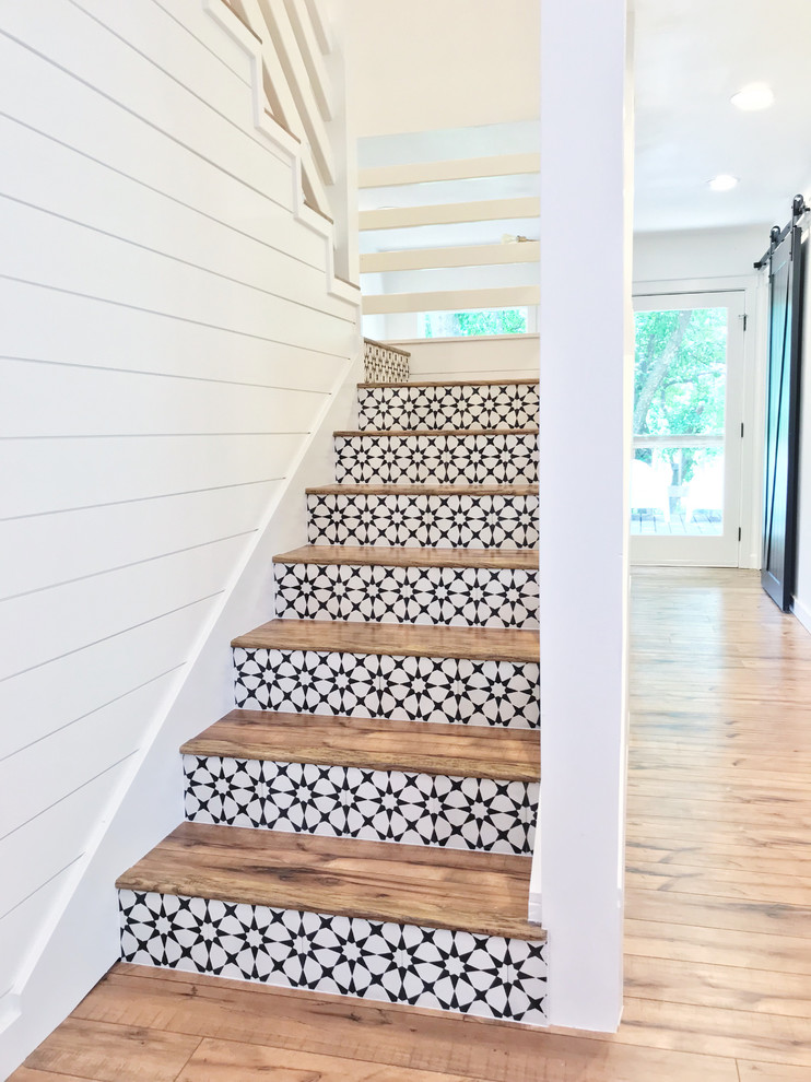 Mid-sized country painted wood curved staircase in Other with wood risers and wood railing.