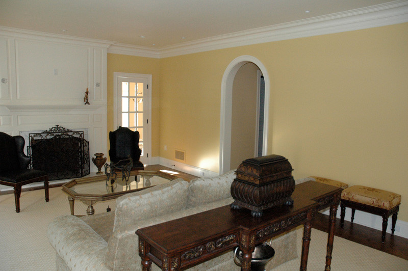 Photo of a mid-sized traditional formal open concept living room in Philadelphia with yellow walls, carpet, a standard fireplace and a metal fireplace surround.