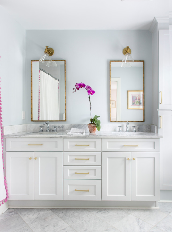 Inspiration for a transitional master white tile and porcelain tile marble floor and gray floor drop-in bathtub remodel with shaker cabinets, white cabinets, a one-piece toilet, blue walls, an undermount sink and marble countertops