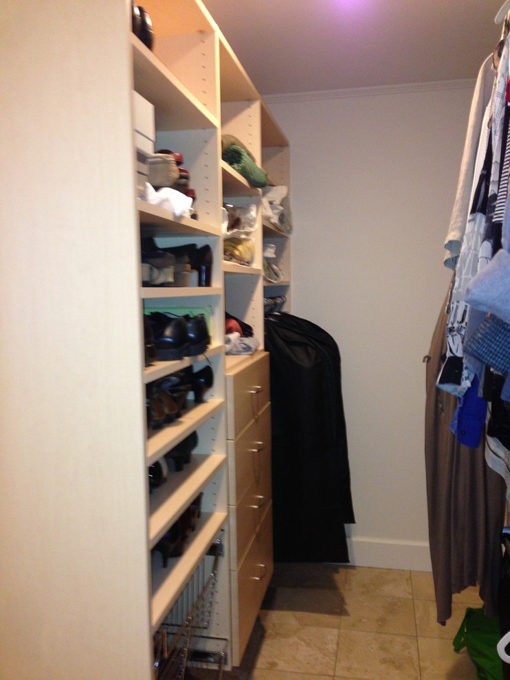 Small traditional walk-in wardrobe in Manchester with light wood cabinets and porcelain floors.