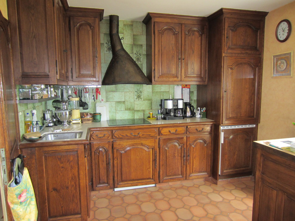 This is an example of a mid-sized traditional galley separate kitchen in Paris with a single-bowl sink, shaker cabinets, white cabinets, granite benchtops, green splashback, ceramic splashback, stainless steel appliances, terra-cotta floors, multiple islands and red floor.