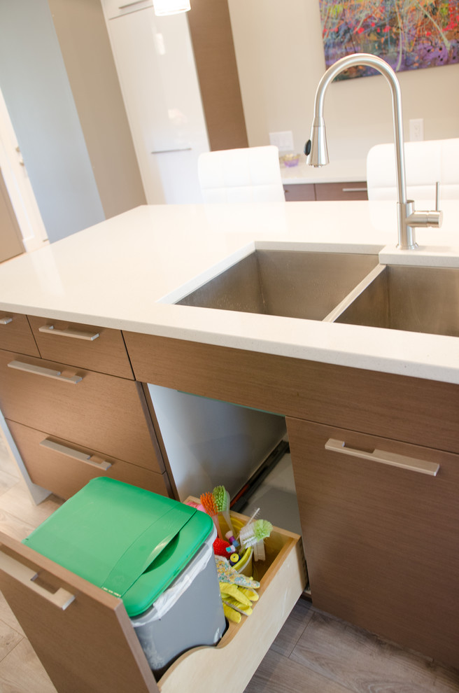 Example of a mid-sized minimalist u-shaped dark wood floor eat-in kitchen design with a double-bowl sink, flat-panel cabinets, medium tone wood cabinets, quartzite countertops, white backsplash, mosaic tile backsplash, stainless steel appliances and an island