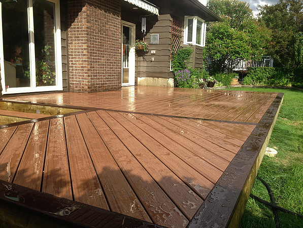 Example of a mid-sized mountain style backyard deck design in Calgary