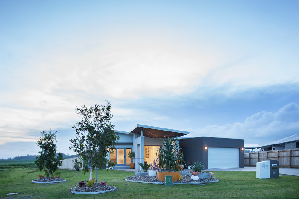 Inspiration for a mid-sized contemporary one-storey grey house exterior in Other with mixed siding, a shed roof and a metal roof.