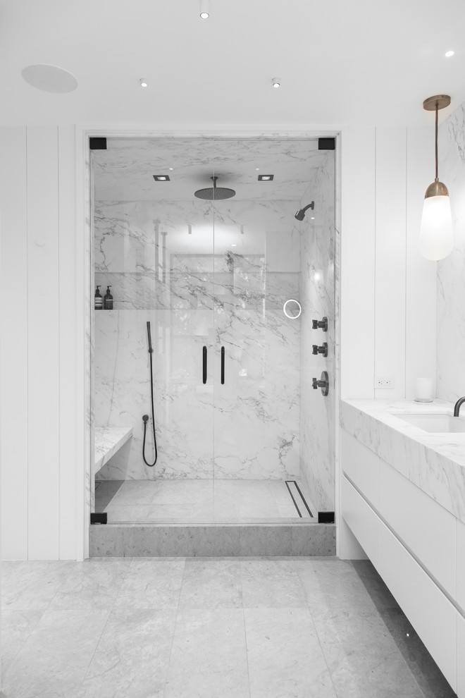 Large contemporary master bathroom in Salt Lake City with white cabinets, a freestanding tub, white tile, marble, white walls, an undermount sink, marble benchtops, a hinged shower door and white benchtops.