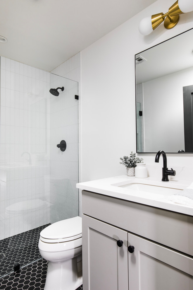 Mid-sized transitional kids' white tile ceramic tile and black floor alcove shower photo in Phoenix with shaker cabinets, gray cabinets, quartz countertops, a hinged shower door and a built-in vanity