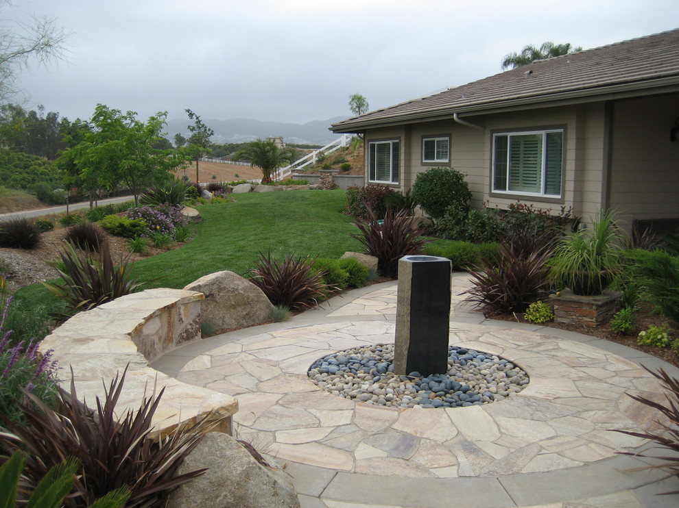 Transitional backyard garden in San Diego with a water feature and natural stone pavers.
