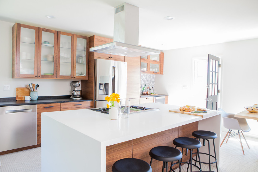 Midcentury open plan kitchen in San Francisco with a farmhouse sink, flat-panel cabinets, medium wood cabinets, quartz benchtops, multi-coloured splashback, ceramic splashback, stainless steel appliances, porcelain floors, with island and white floor.