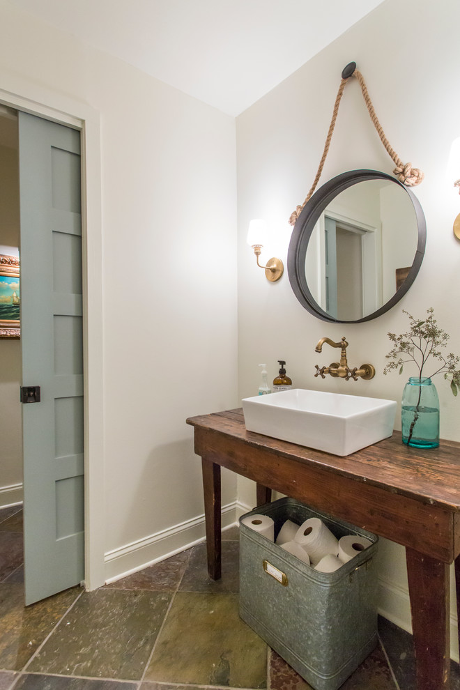 Country powder room in Atlanta with a vessel sink, furniture-like cabinets, dark wood cabinets, wood benchtops, white walls and brown benchtops.