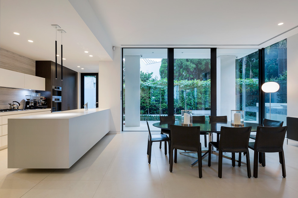 Inspiration for a large contemporary galley eat-in kitchen in Melbourne with white cabinets, quartz benchtops, ceramic floors and with island.