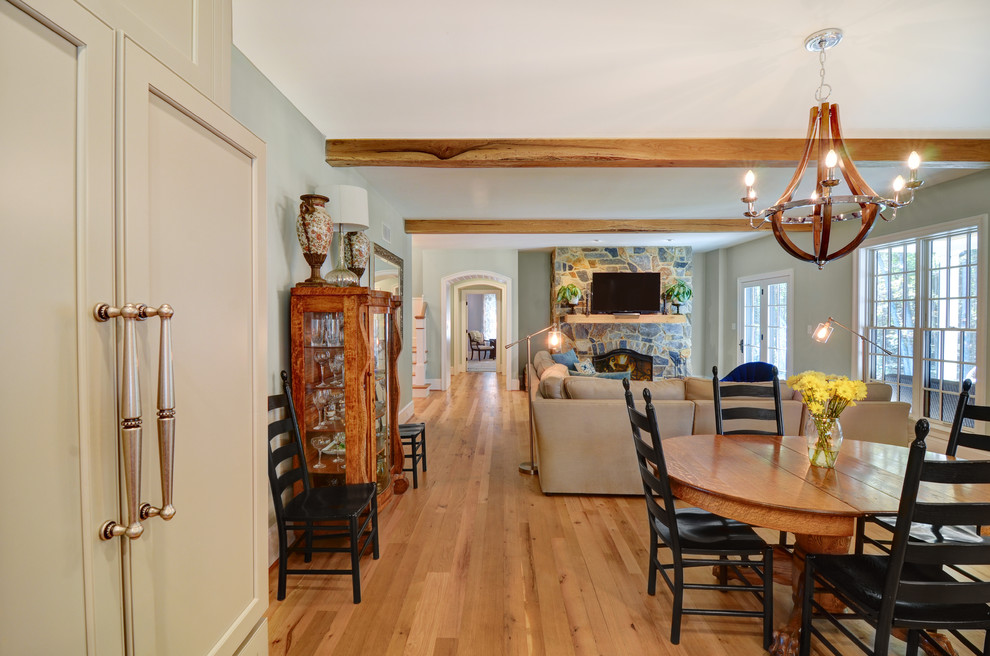 Large transitional open concept light wood floor and beige floor great room photo in Baltimore with gray walls, a standard fireplace, a stone fireplace and a wall-mounted tv
