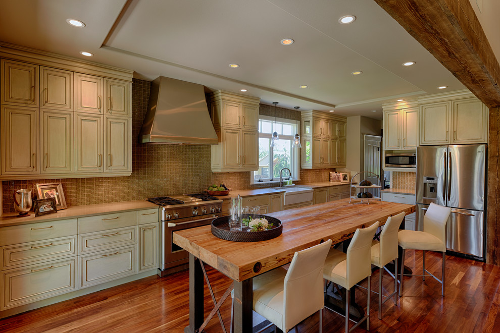 Open concept kitchen - large transitional l-shaped dark wood floor open concept kitchen idea in Seattle with a farmhouse sink, recessed-panel cabinets, distressed cabinets, quartz countertops, gray backsplash, glass tile backsplash, stainless steel appliances and an island