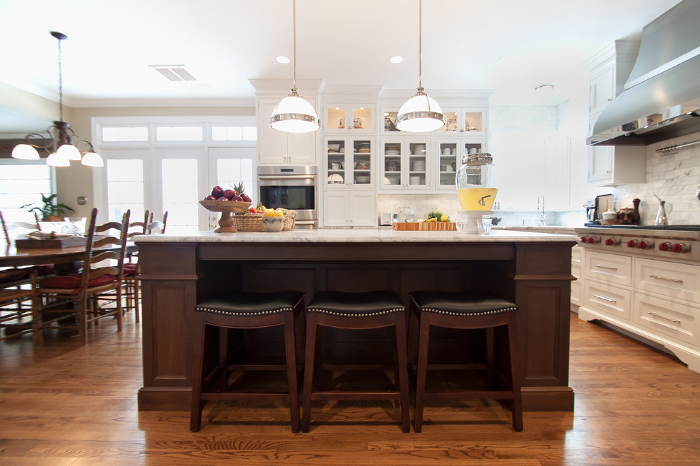 Inspiration for a large transitional kitchen remodel in DC Metro with beaded inset cabinets, white cabinets, marble countertops, white backsplash, subway tile backsplash, stainless steel appliances and an island