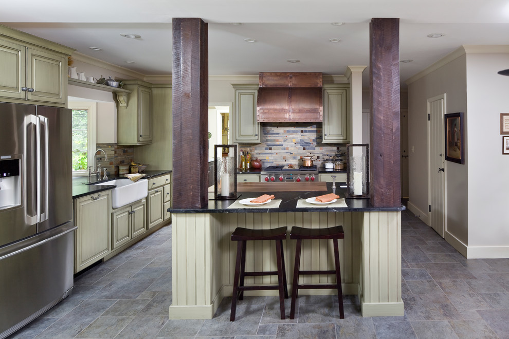 Eat-in kitchen - transitional eat-in kitchen idea in Indianapolis with a drop-in sink, multicolored backsplash, stainless steel appliances, green cabinets and an island