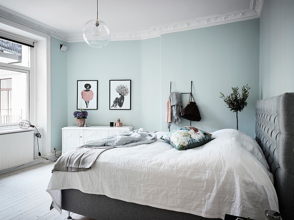 Design ideas for a scandinavian bedroom in Gothenburg with blue walls and white floor.