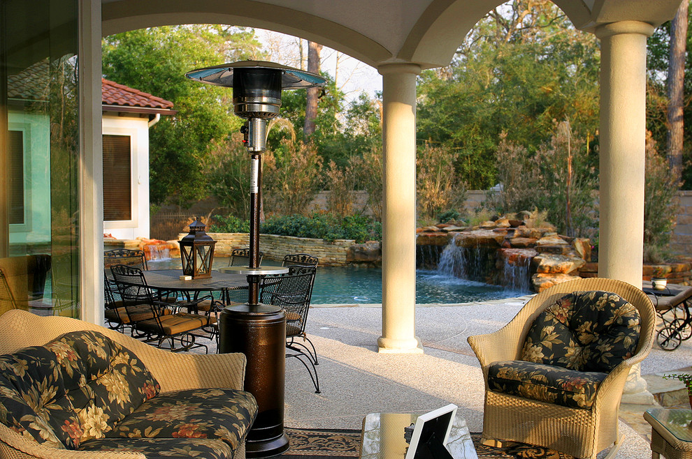 Example of a mid-sized classic backyard concrete patio design in Houston with a roof extension