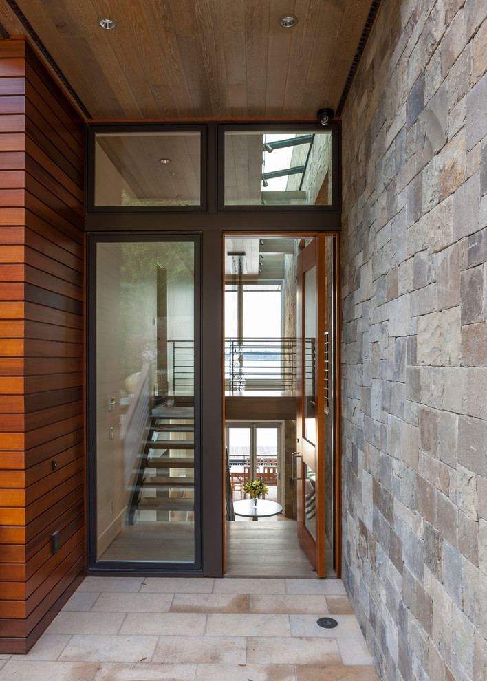 This is an example of a large contemporary front door in Seattle with a double front door and a glass front door.