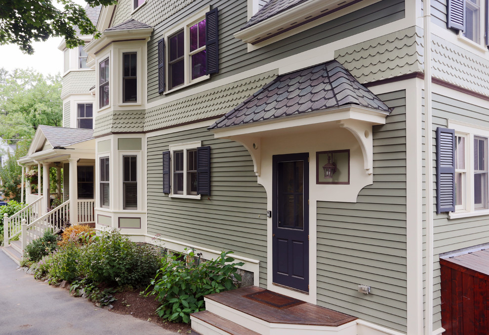 Large traditional two-storey green exterior in Boston with wood siding.