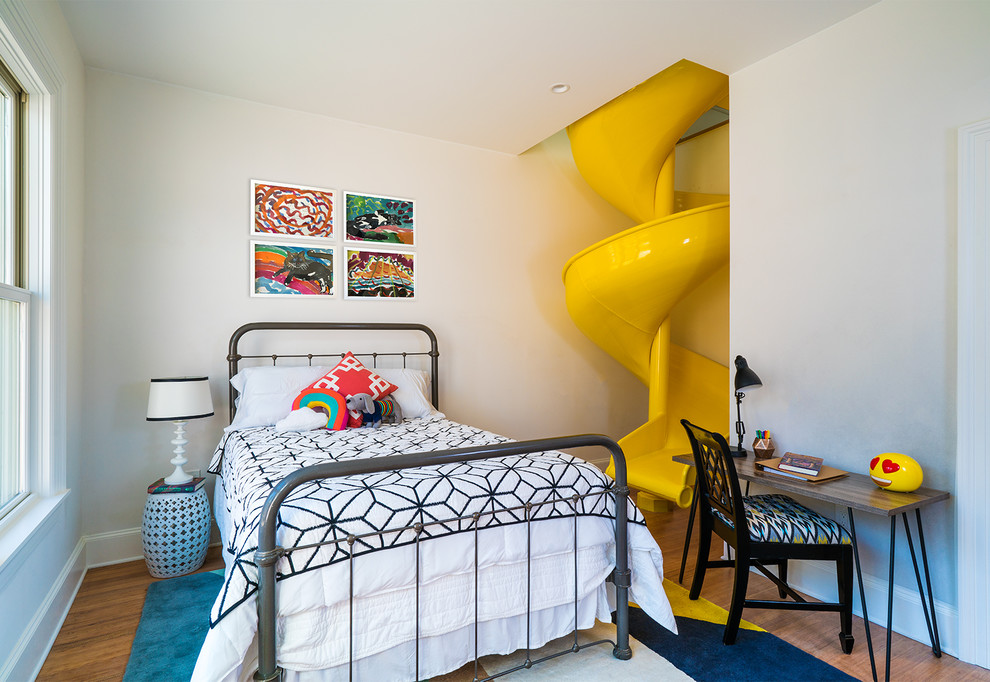 This is an example of a contemporary kids' bedroom for kids 4-10 years old and girls in Austin with white walls, medium hardwood floors and brown floor.