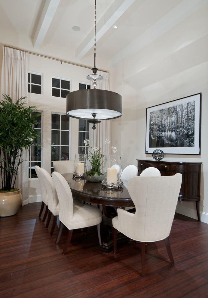 Photo of a traditional dining room in Miami with white walls and dark hardwood floors.
