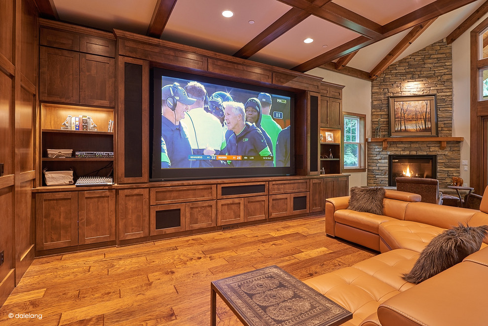 Inspiration for a large transitional open concept home theatre in Seattle with white walls, dark hardwood floors, a projector screen and brown floor.