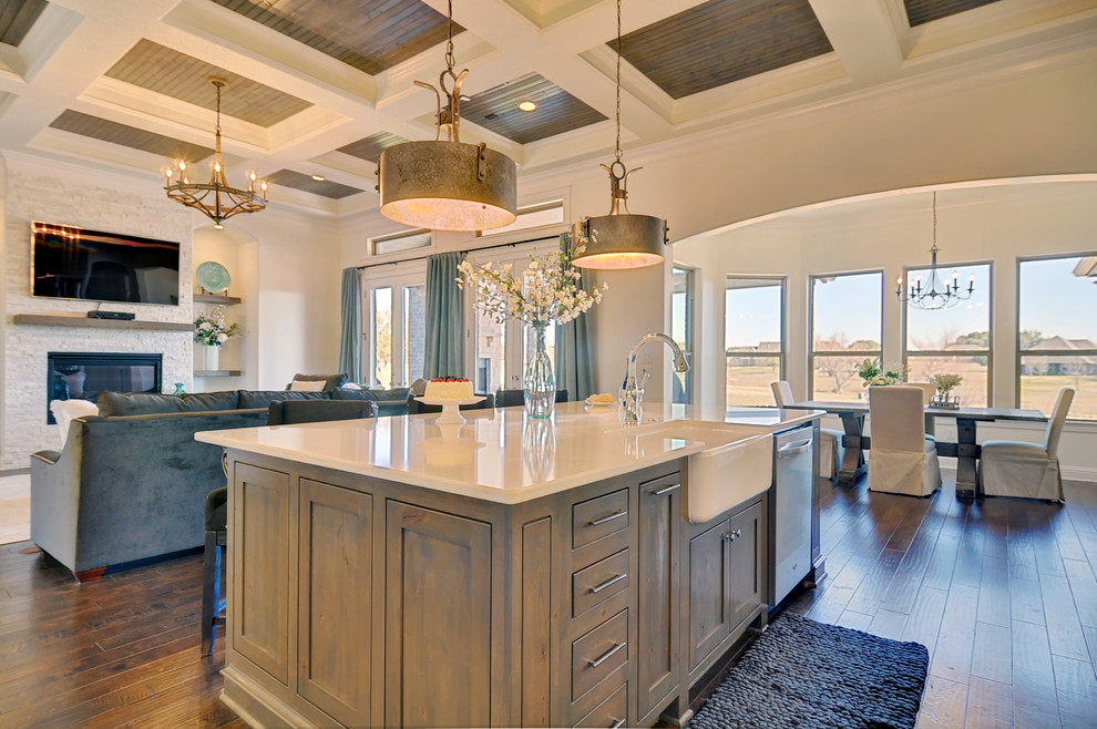 This is an example of a large transitional l-shaped eat-in kitchen in Dallas with a farmhouse sink, shaker cabinets, grey cabinets, quartz benchtops, grey splashback, stone tile splashback, stainless steel appliances, dark hardwood floors and with island.