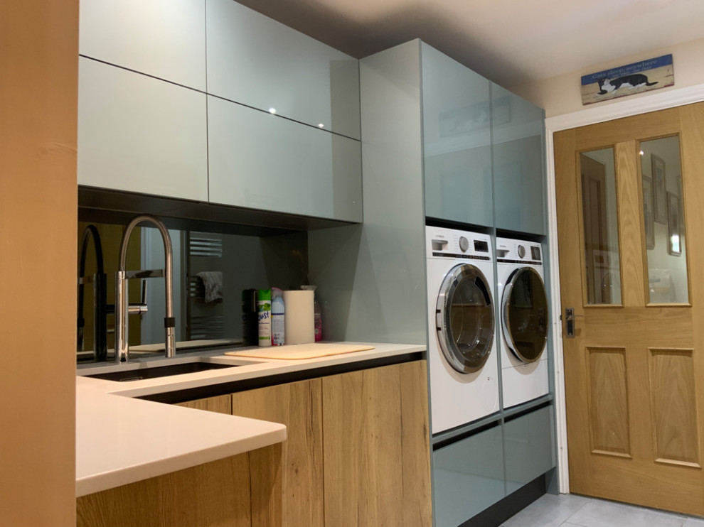 Inspiration for a large modern l-shaped utility room in Buckinghamshire with beaded inset cabinets, grey cabinets and wood benchtops.