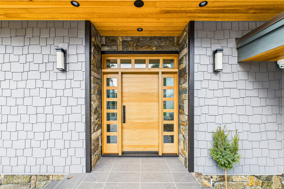 Inspiration for a contemporary front door remodel with a medium wood front door