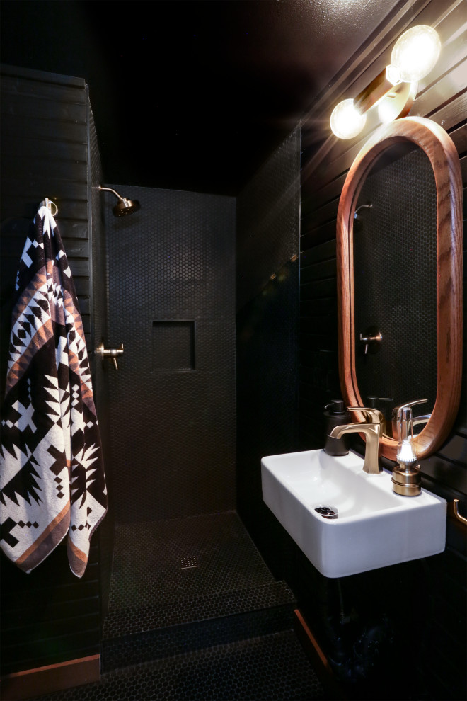 This is an example of a small country bathroom in Portland with an alcove shower, black tile, ceramic tile, black walls, ceramic floors, a wall-mount sink, black floor, an open shower, a single vanity, a floating vanity and planked wall panelling.