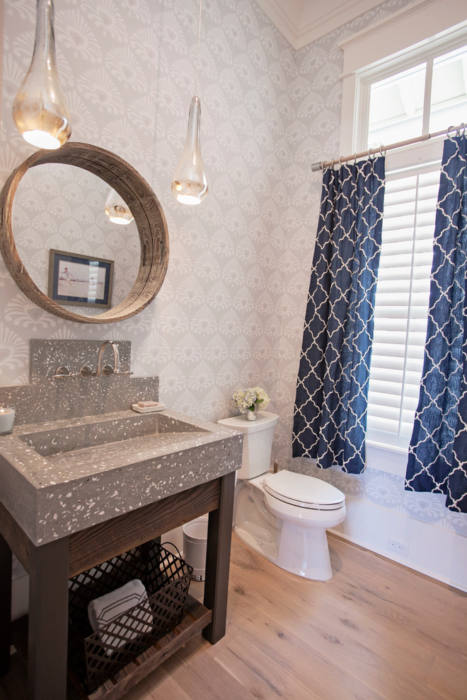 Large transitional powder room in Atlanta with open cabinets, dark wood cabinets, a two-piece toilet, grey walls, medium hardwood floors, an integrated sink and terrazzo benchtops.