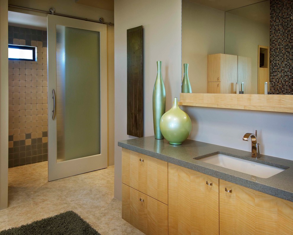 Inspiration for an expansive modern bathroom in Phoenix with a drop-in sink, flat-panel cabinets, quartzite benchtops, a curbless shower, beige tile and porcelain floors.