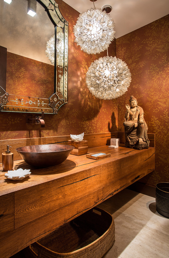 This is an example of an asian powder room in Miami with wood benchtops, brown walls and brown benchtops.
