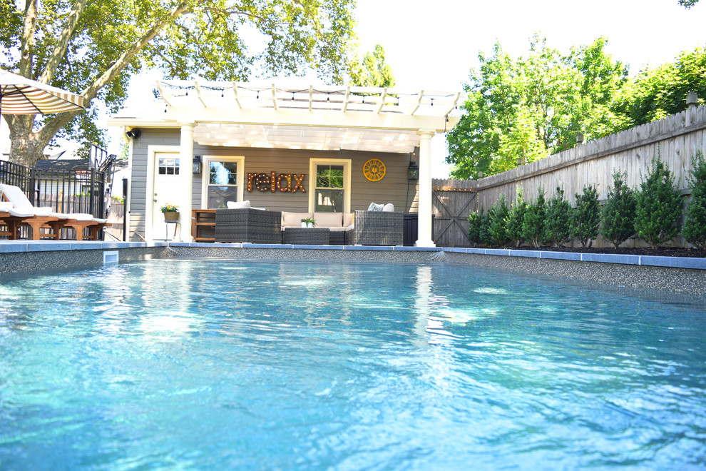 This is an example of a mid-sized transitional backyard rectangular lap pool in New York with concrete pavers.