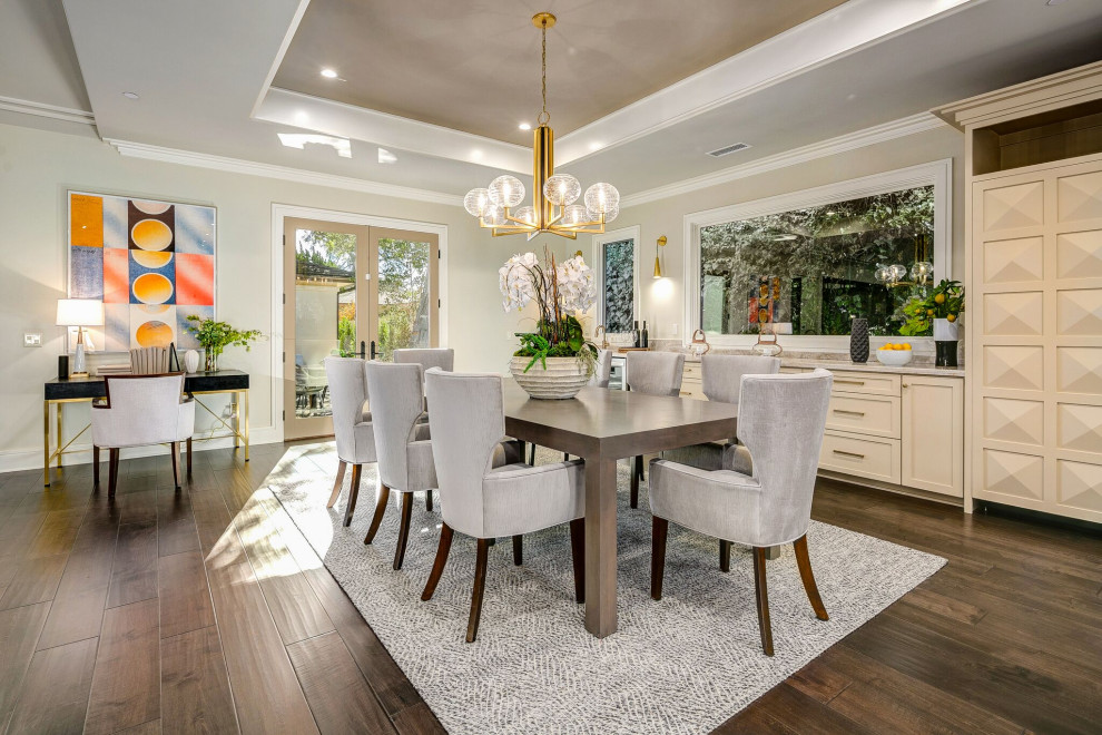 Inspiration for a transitional dining room in Los Angeles with beige walls, dark hardwood floors, brown floor and recessed.