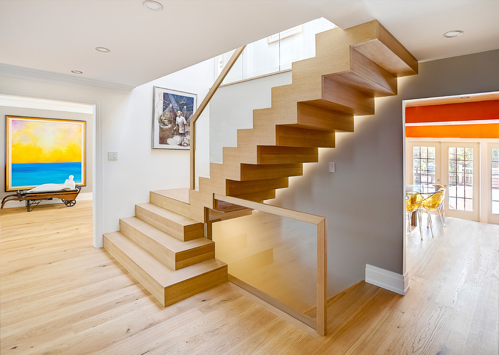Photo of a mid-sized contemporary wood l-shaped staircase in Toronto with wood risers.