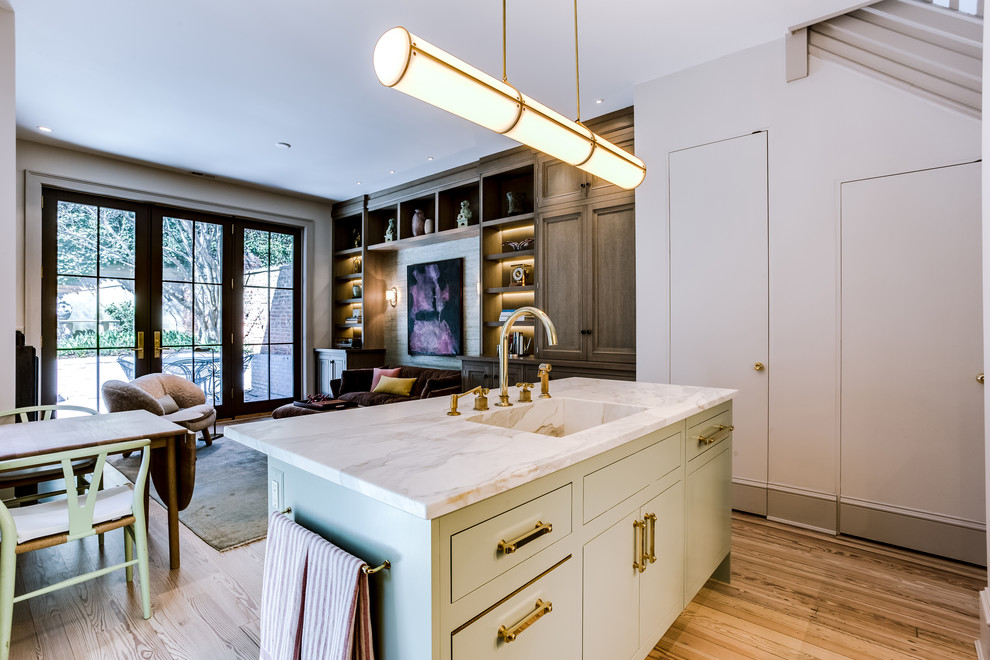 Inspiration for a mid-sized transitional l-shaped kitchen in DC Metro with an integrated sink, flat-panel cabinets, green cabinets, quartzite benchtops, stainless steel appliances, light hardwood floors, with island and brown floor.